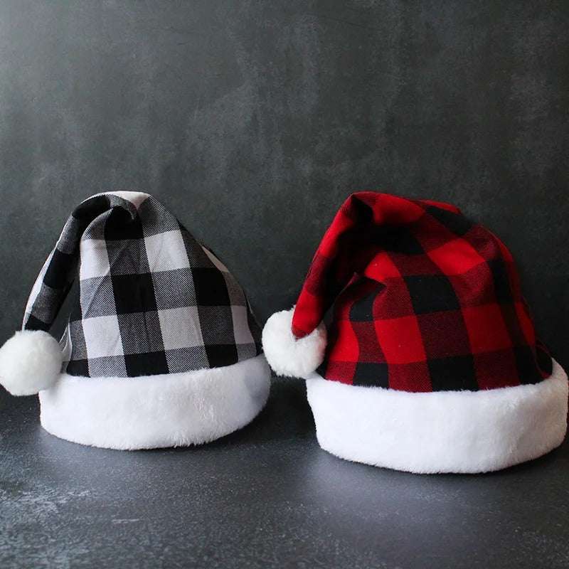 Red and black plaid party Christmas hats with white fluffy trim and pom-poms on dark background