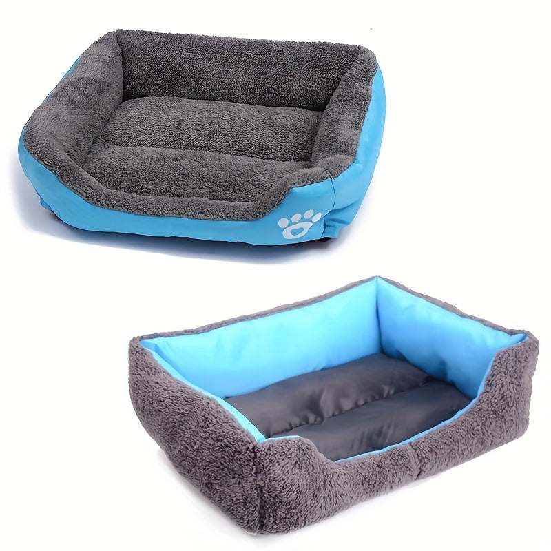 Large washable dog bed with blue exterior and gray plush interior featuring paw print design, rectangular shape made of durable polyester fiber