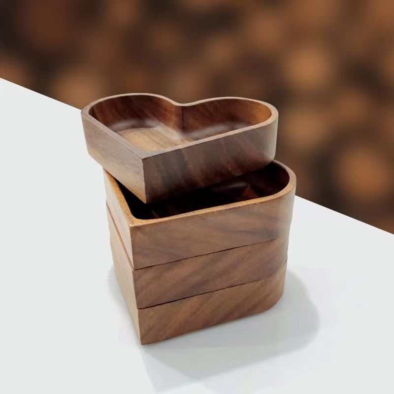 Heart-shaped walnut-colored wooden tray stack for serving snacks and appetizers