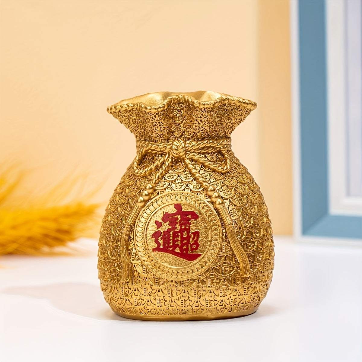 Golden Chinese style money bag ornament with intricate pattern and red Chinese character for home decor