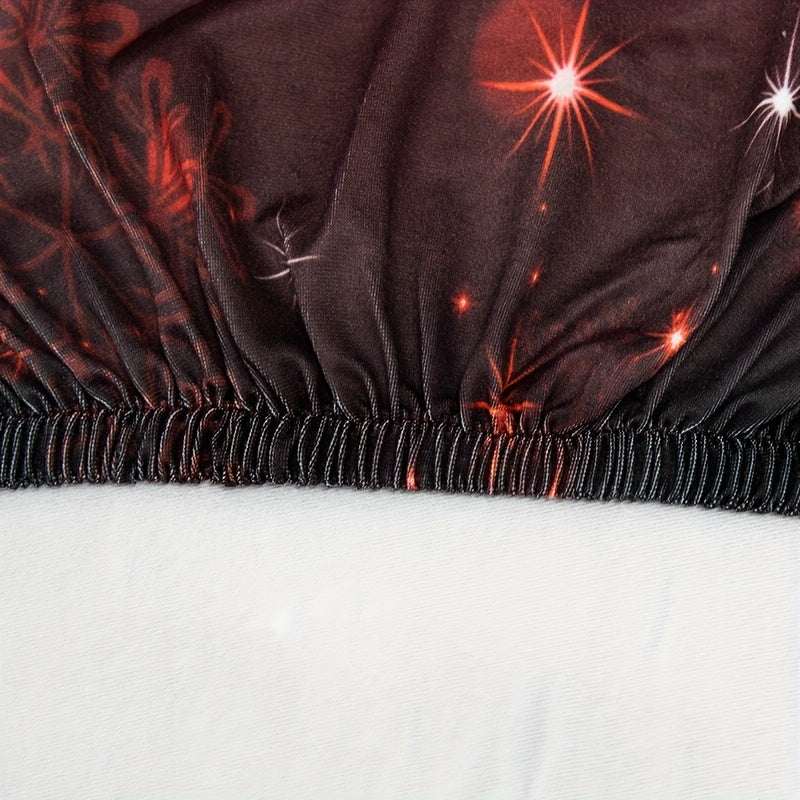 Close-up of elastic band on red bells pattern milk velvet dining chair slipcover with Christmas decor design