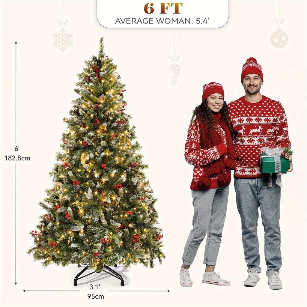 6 ft pre-lit pre-decorated pine artificial Christmas tree with frosted tips, lights, pine cones, and red berries next to couple in holiday sweaters