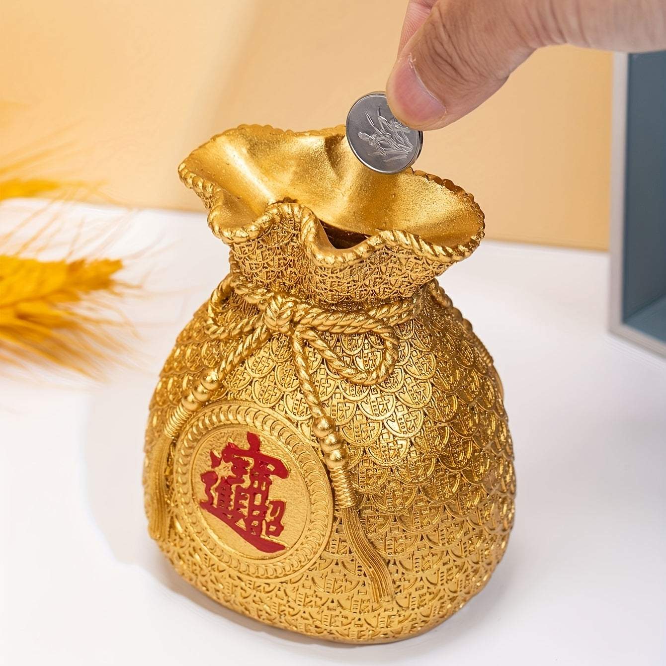 Golden Chinese style money bag ornament with intricate design for tabletop coin storage and home decor