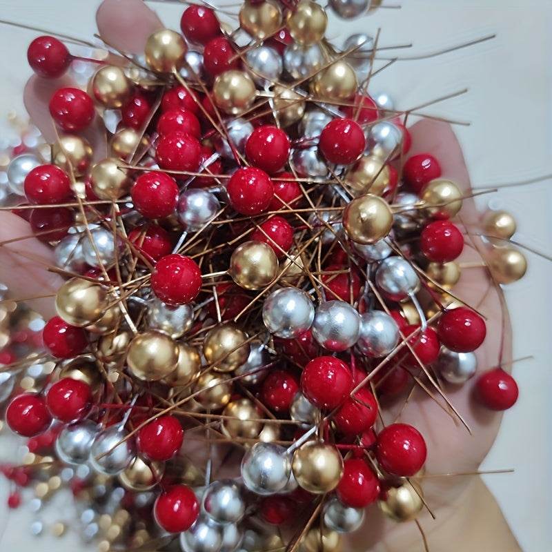 Hand holding 100pcs vibrant mixed color artificial red berries in red, gold, and silver for holiday decor and DIY wreaths