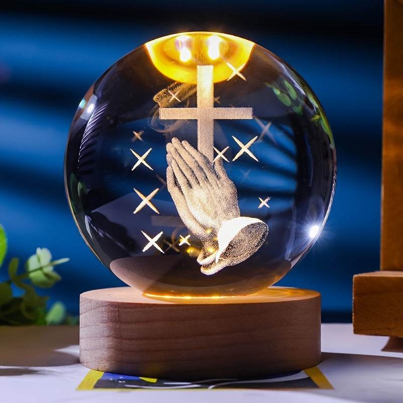 Luminescent crystal ball with praying hands and cross design on wooden base nightlight
