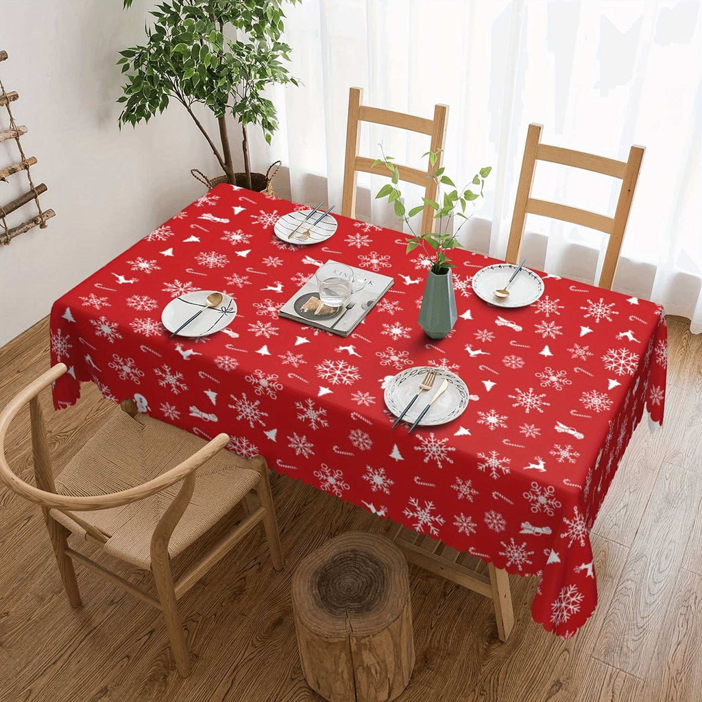 Red polyester tablecloth with white snowflake and bell pattern on dining table for Christmas decor