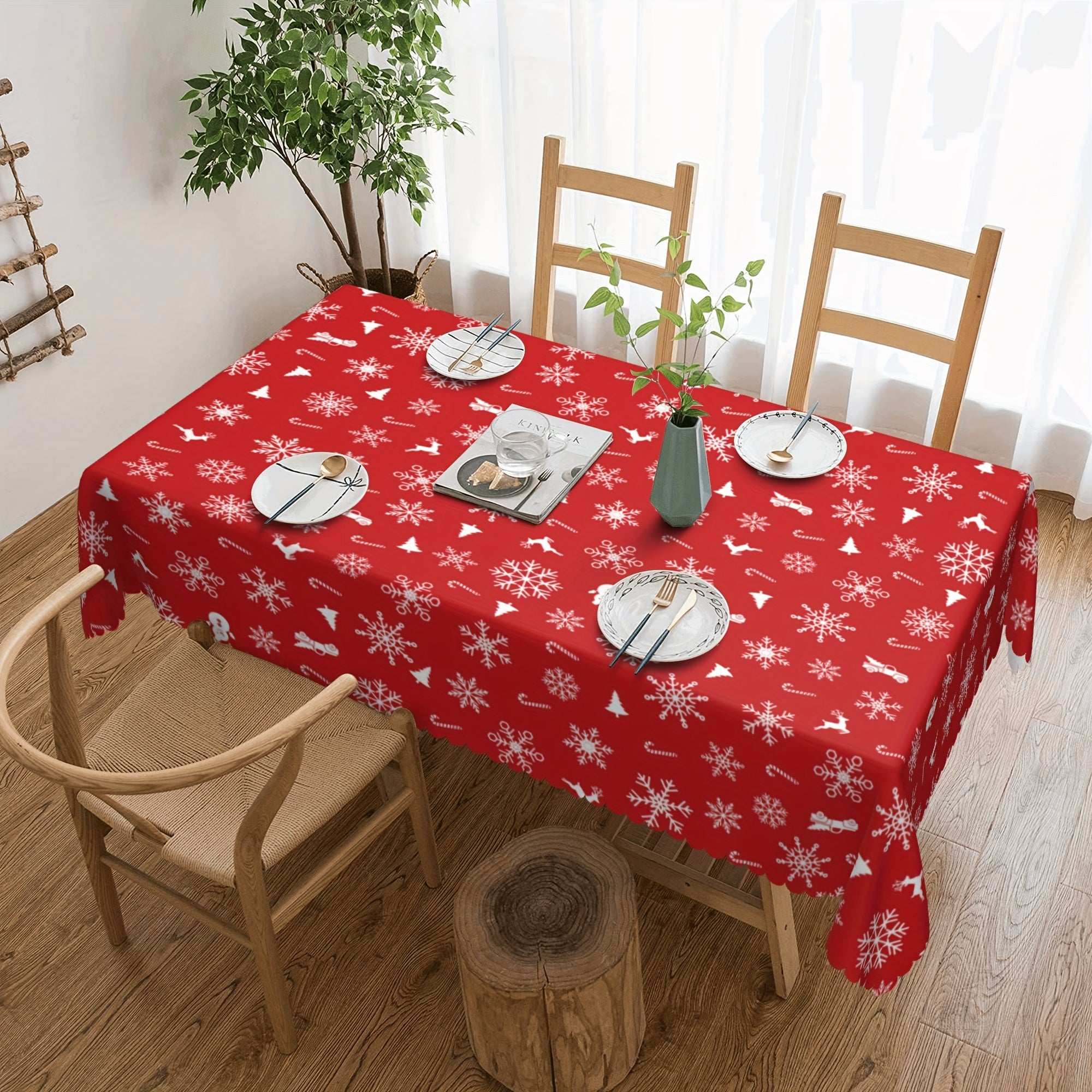 Red polyester tablecloth with white snowflake and bell pattern on dining table for Christmas decor