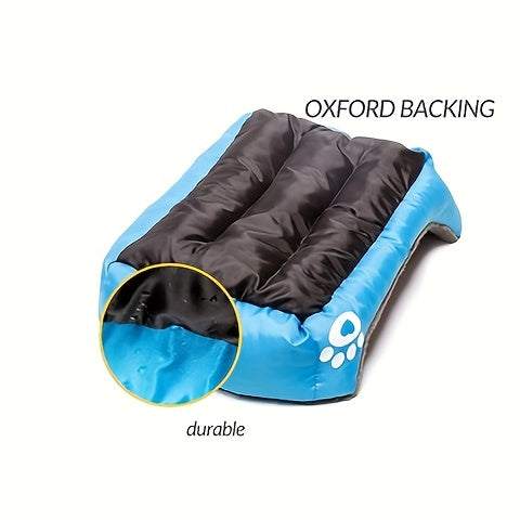 Large washable dog bed with durable oxford backing and paw print design in blue and black colors