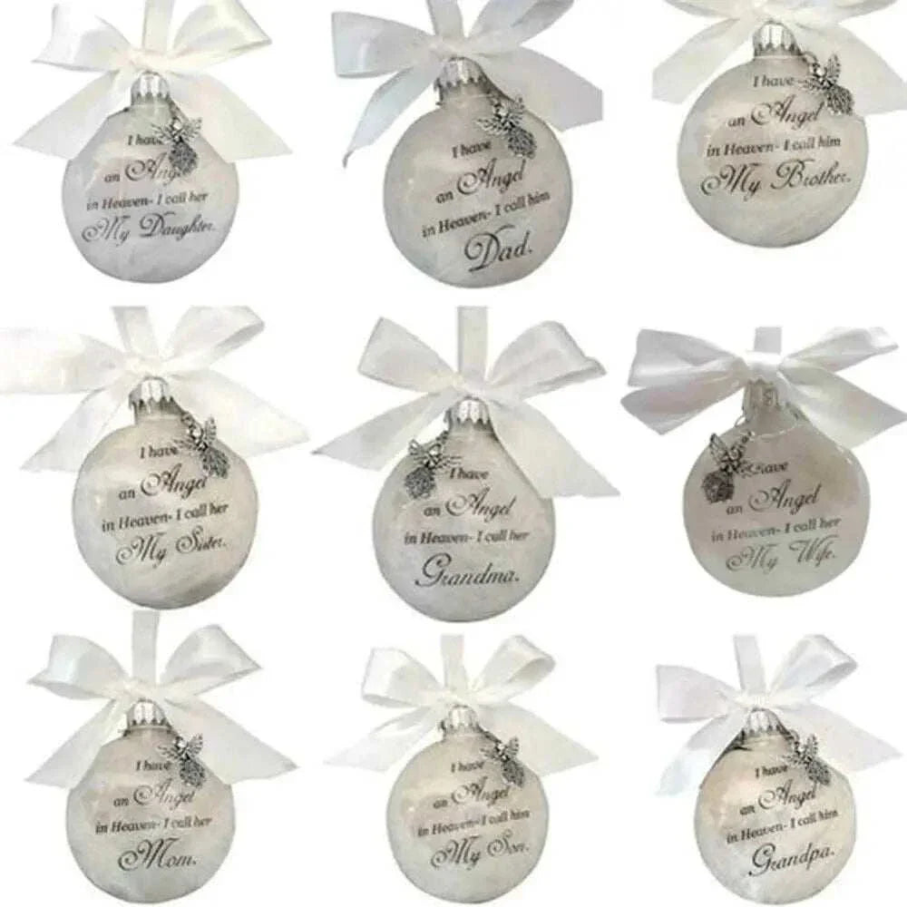 Set of white Christmas Memory Balls with engraved angel wing design and personalized inscriptions for lost loved ones, decorated with white ribbons and charms.