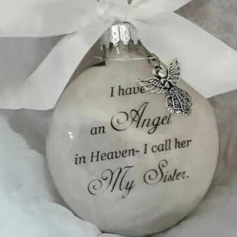 White Christmas memory ball ornament with angel charm and "I have an angel in Heaven - I call her my sister" text decoration