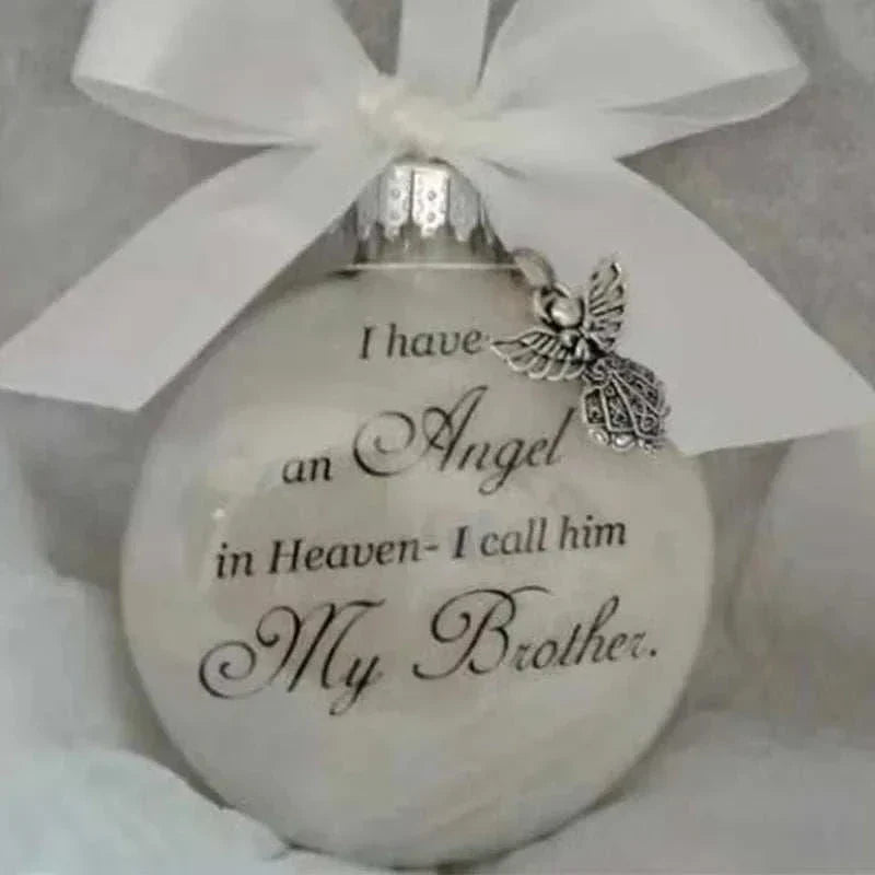 White plastic Christmas memory ball ornament with angel charm and "I have an Angel in Heaven - I call him My Brother" inscription