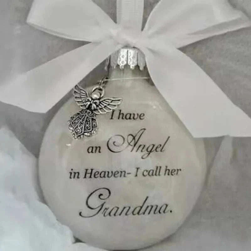 White Christmas memory ball ornament with silver angel charm and "I have an Angel in Heaven- I call her Grandma" text pendant