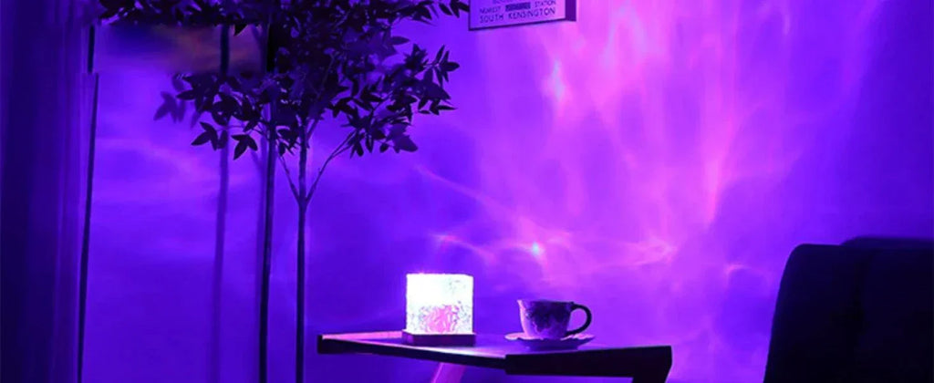 ocean wave projector light casting purple underwater glow on wall next to table with cup and plant