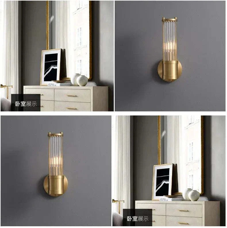 Modern gold luxury wall lamp with clear glass shade mounted on gray wall in bedroom setting