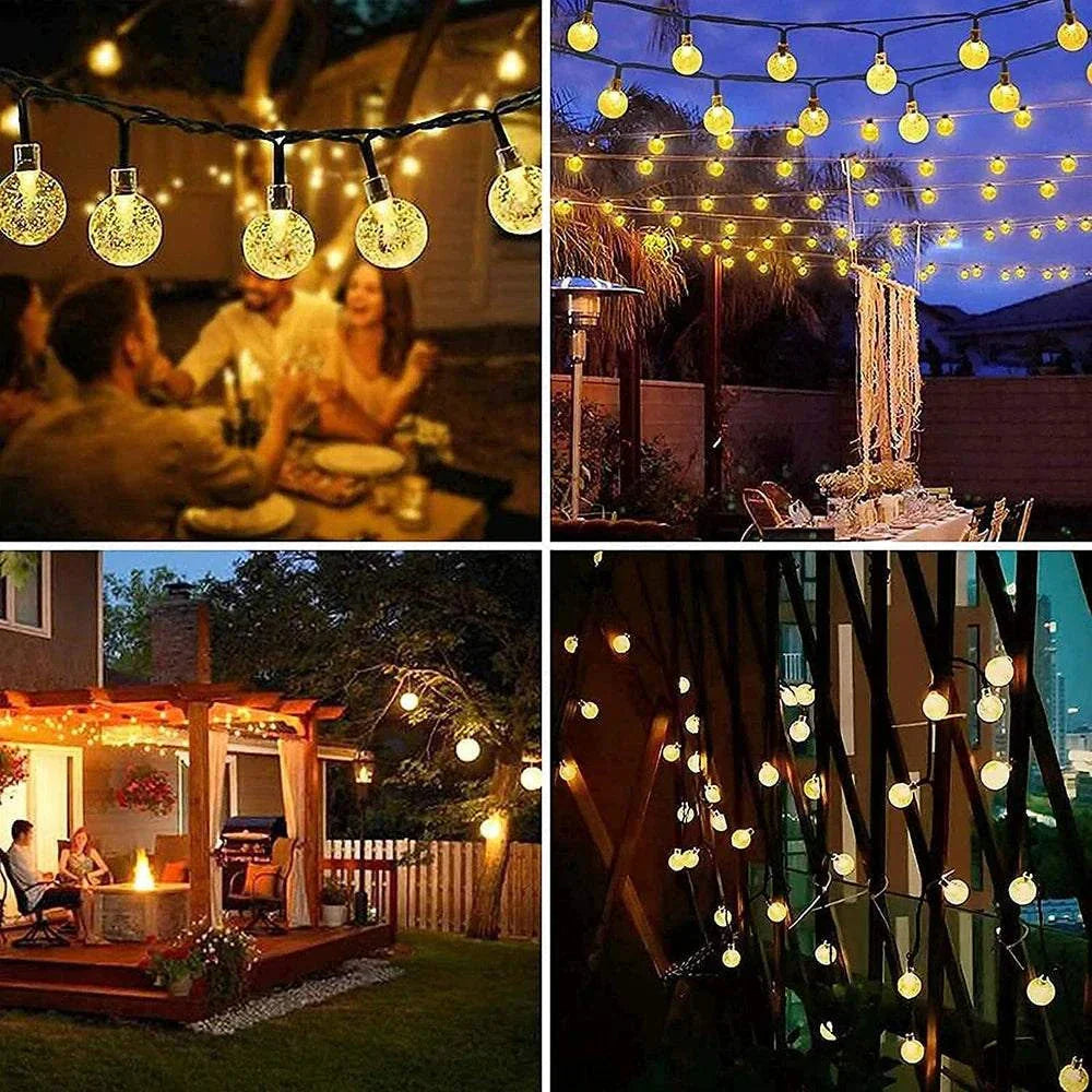 Solar Bubble Ball String Lights glowing warmly in outdoor garden and patio settings for Christmas and holiday decoration