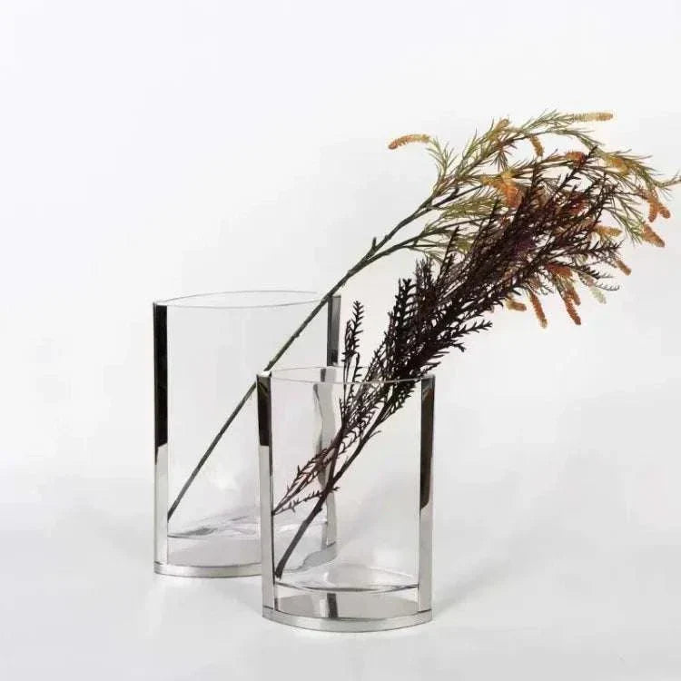 Modern glass vase with metal accents holding decorative dried flowers, modern minimalist home decor accessory