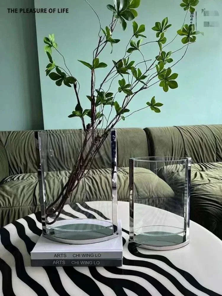 Modern glass vases with metal base in minimalist home decor setting