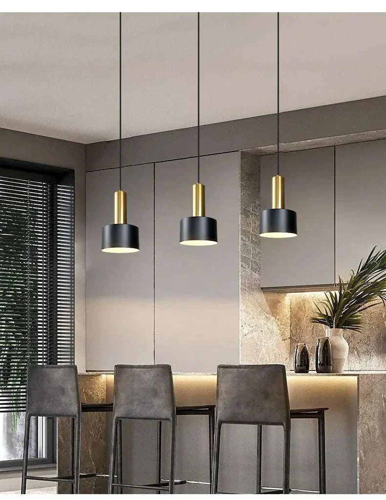 Nordic simple three-chandelier lamp with black and gold pendant lights over modern kitchen island