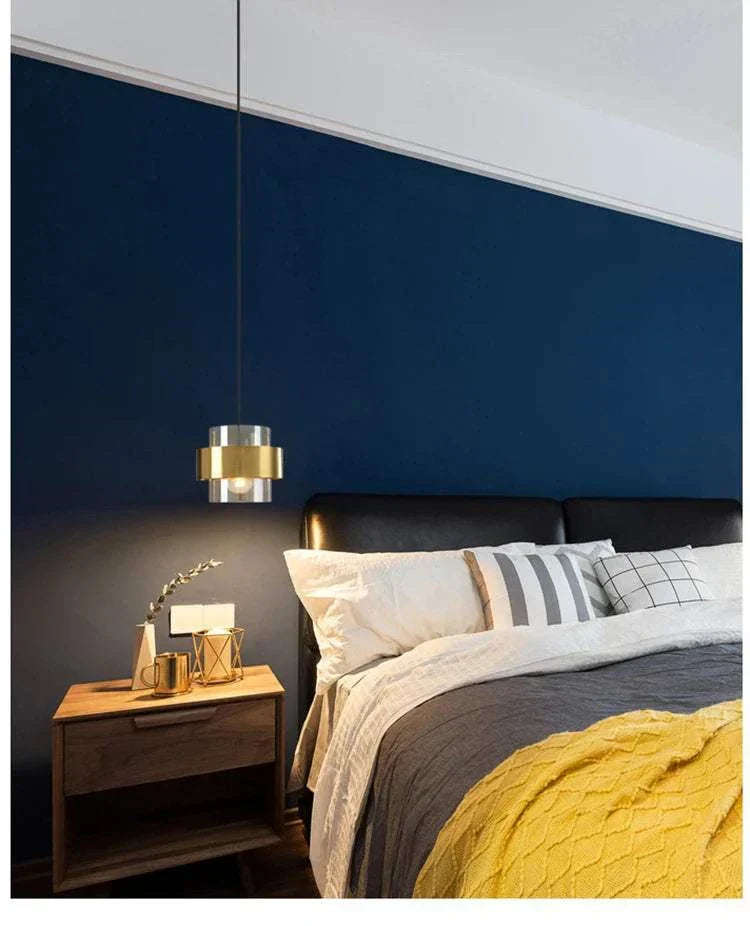 modern bedroom art decor pendant light with metal finish and LED bulb hanging over bedside table
