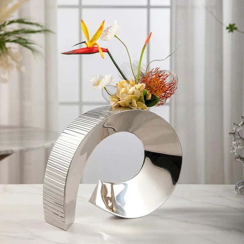 Modern stainless steel curved vase with flowers for living room or office decoration
