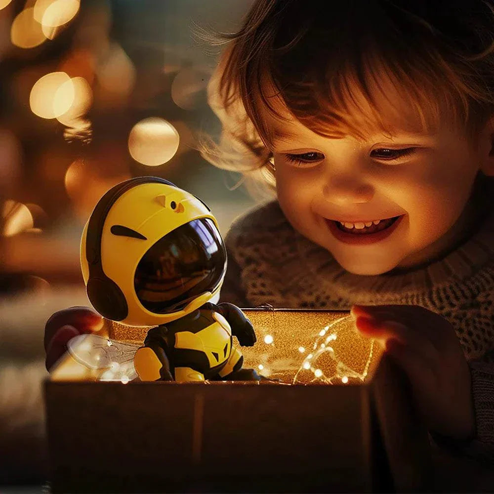 Child smiling while holding Bee Galaxy star projector night light with LED and remote in cozy setting