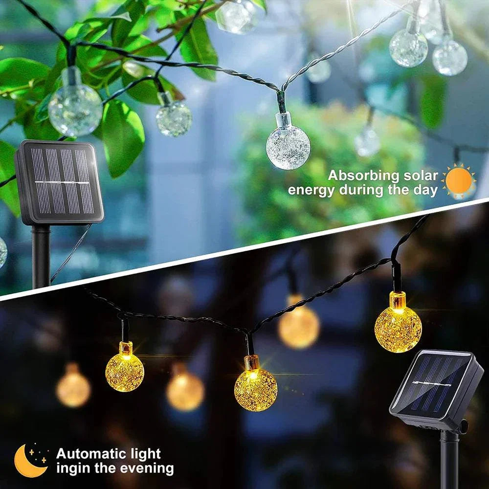 Solar bubble ball string lights with solar panel for outdoor garden decoration, showing daytime energy absorption and warm white LED glow at night.