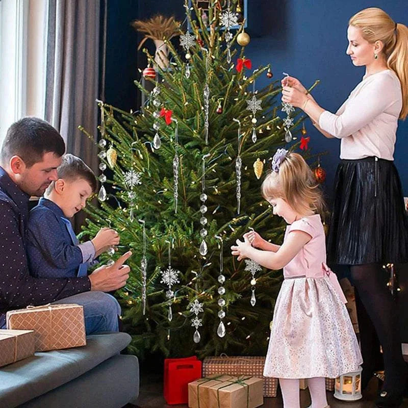 Family decorating Christmas tree with crystal snowflake hanging ornaments for Christmas decoration