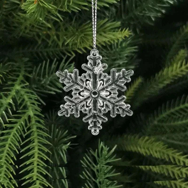 Crystal snowflake Christmas tree ornament hanging on green pine branch Christmas decoration