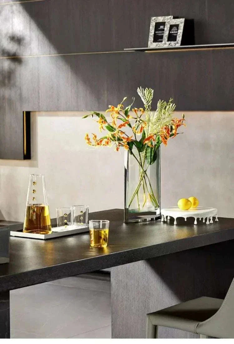 Modern Vase Glass with orange flowers in minimalist home decor setting on black table