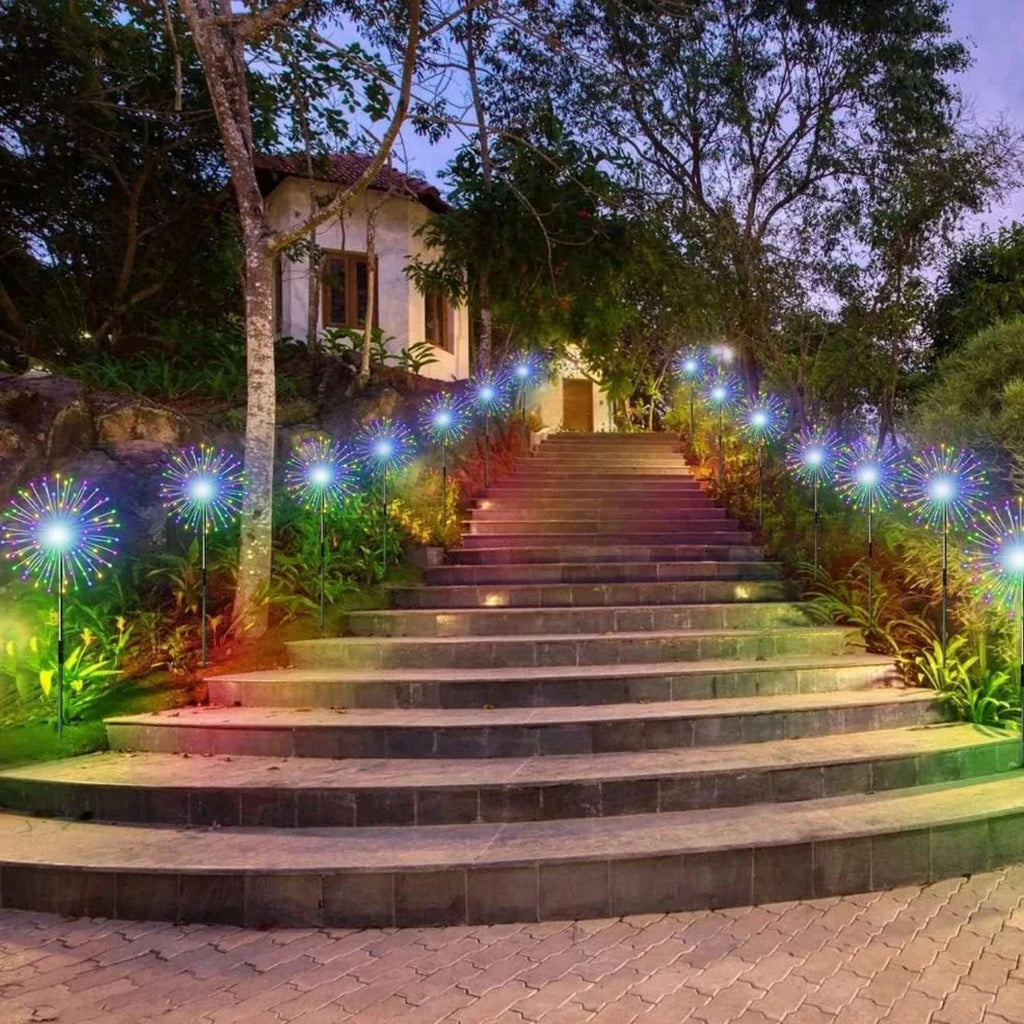 Colorful solar firework string lights decorating outdoor garden stairs at dusk