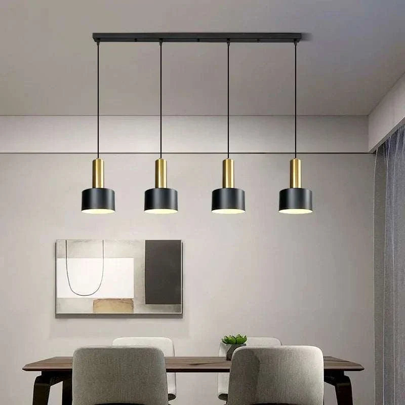 Modern Nordic simple four-chandelier pendant lamp with black and gold metal shades over dining table