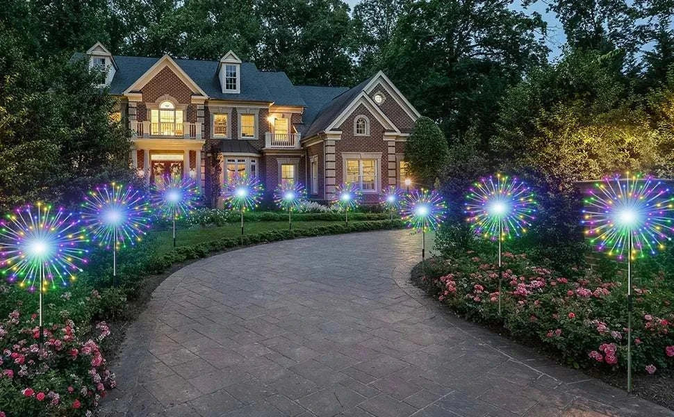 Solar firework string lights decorating garden pathway with colorful glowing fireworks at night