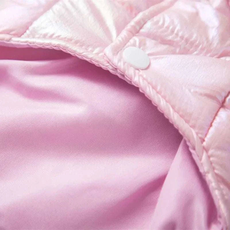 Close-up of pink waterproof winter dog jacket for small pets with button detail