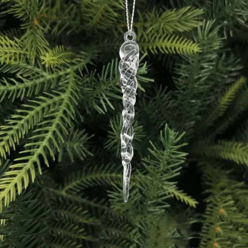 Clear crystal icicle Christmas decoration hanging on a green pine tree branch