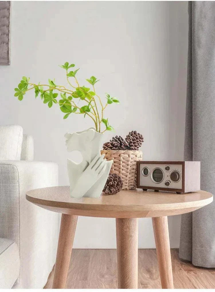 Nordic style ceramic woman body model vase with green plant on wooden table in modern living room decor