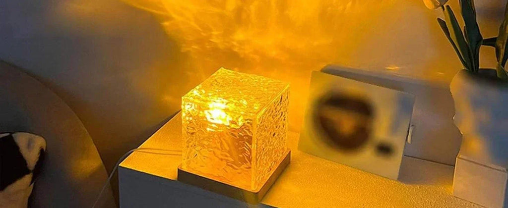 ocean wave projector light emitting warm yellow glow on table in dim room