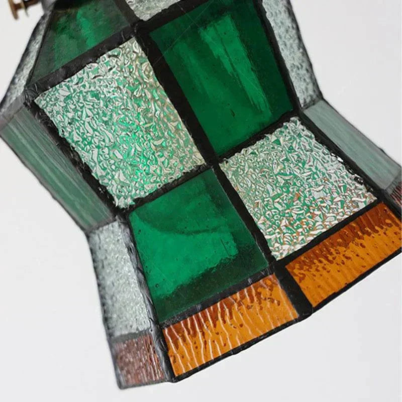 Stained glass wall lamp with green and red panels for bedroom headboard lighting