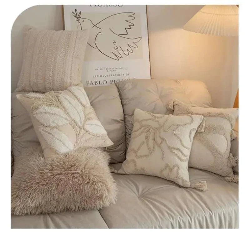 Beige jacquard embroidery cushion covers with tassels on a sofa in a living room setting
