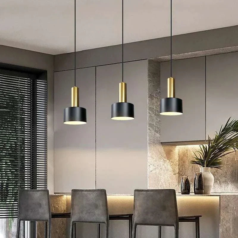 Nordic Simple Three-Chandelier Lamp with sleek metal frame and black gold pendant lights over modern dining table