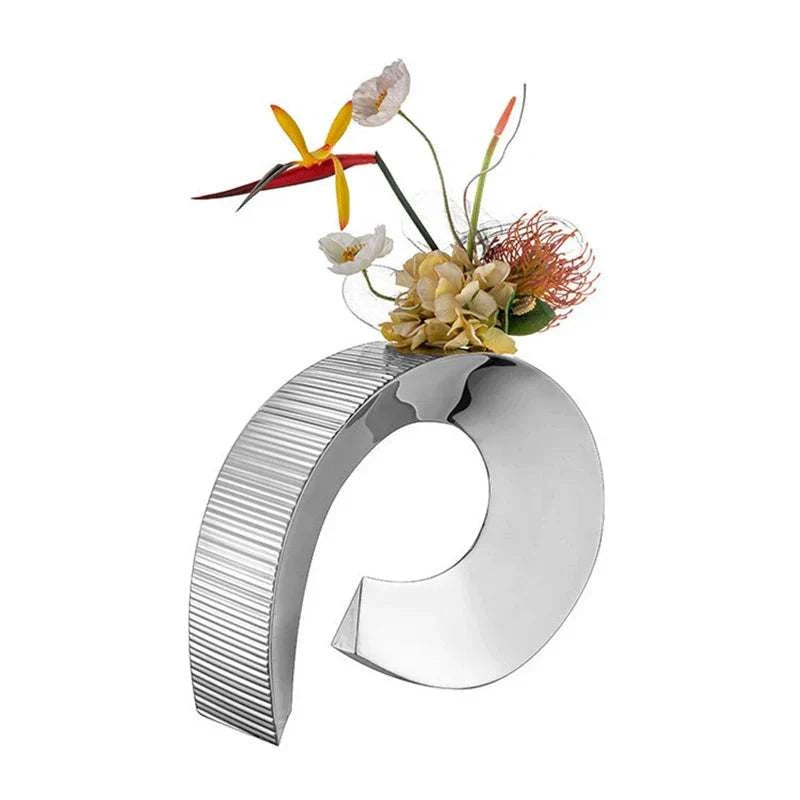modern stainless steel vase with curved design and minimalist flowers decoration