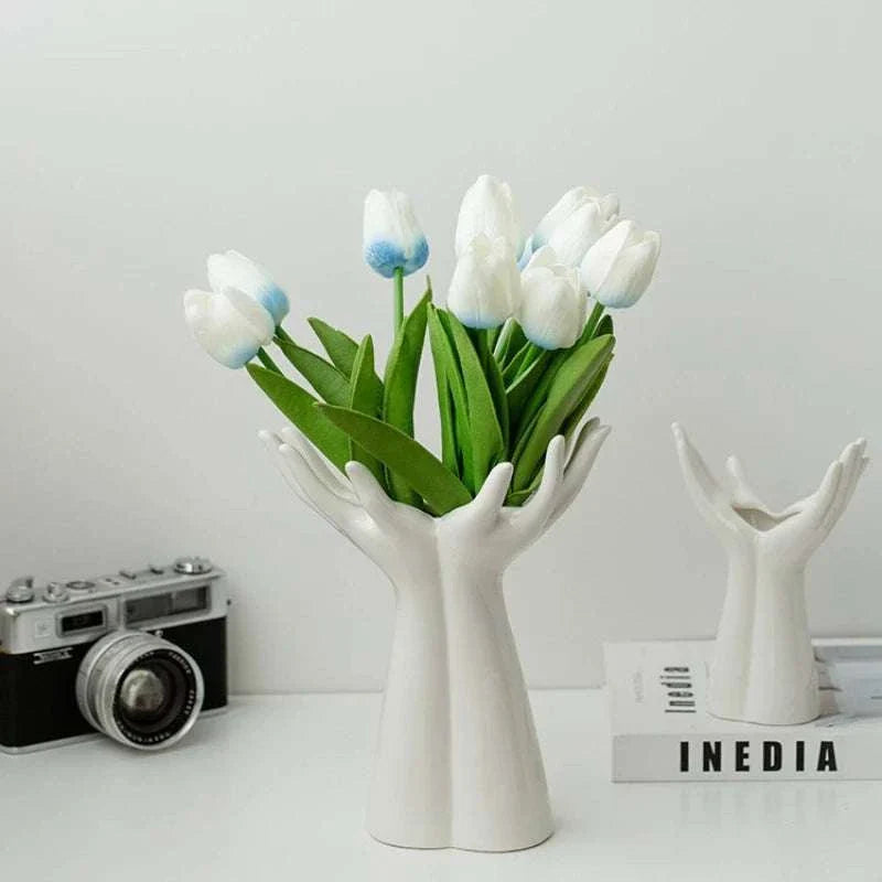Modern ceramic vase shaped like hands holding white tulip bouquet flower arrangement for home decor