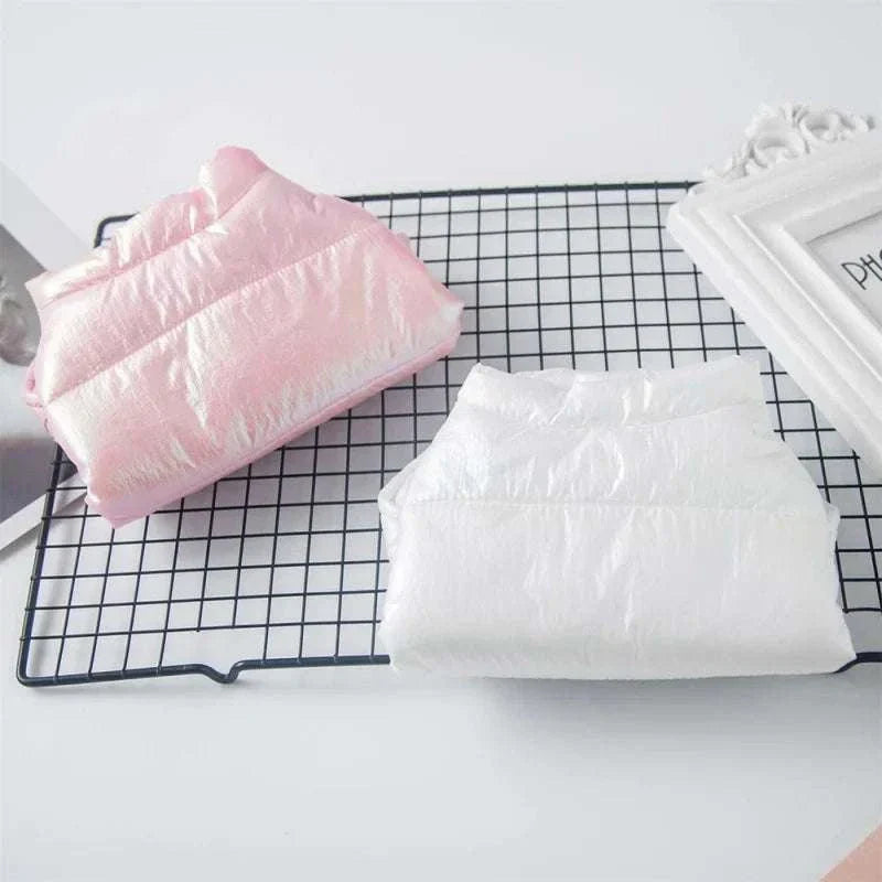 Waterproof pink and white winter pet clothes jackets for small dogs on a grid tray