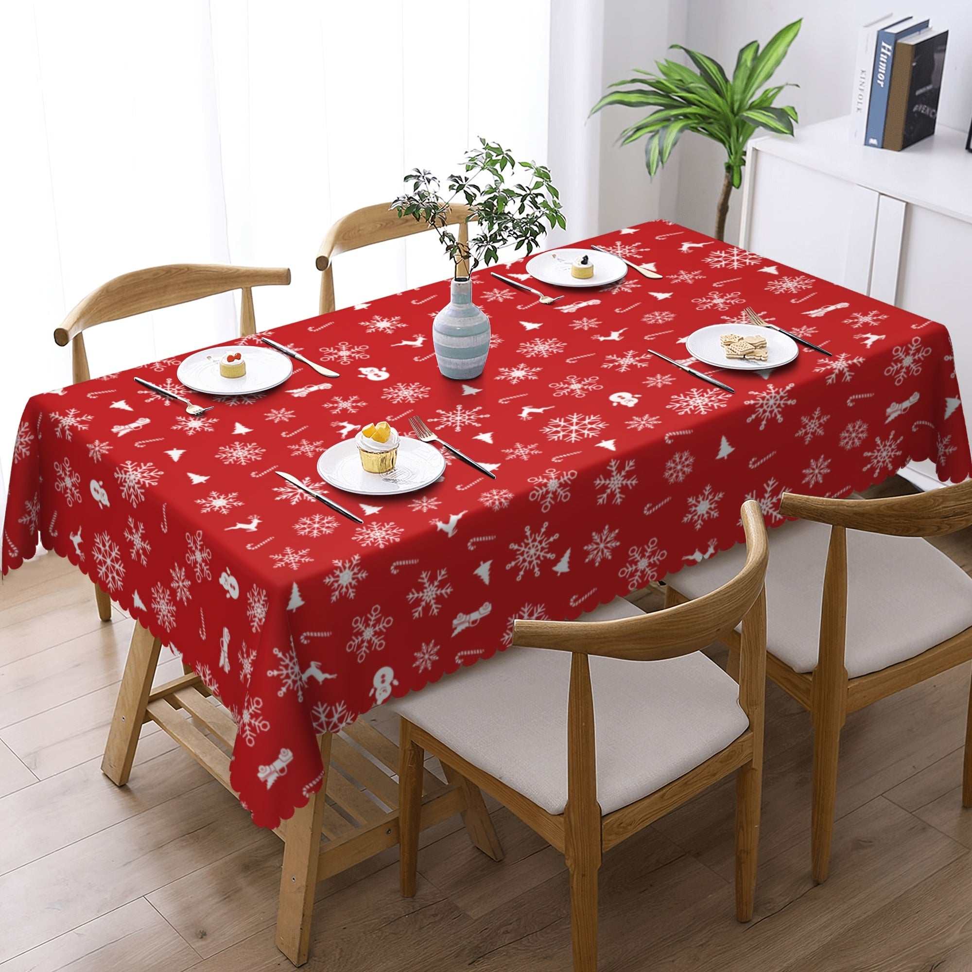 Red Christmas polyester tablecloth with white snowflake and bell pattern on wooden dining table with chairs
