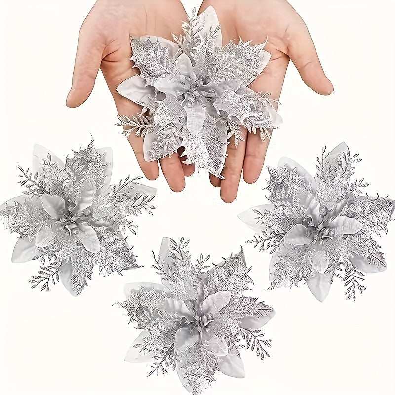 Hand holding silver glitter poinsettia artificial flower with three more on white background Christmas decor