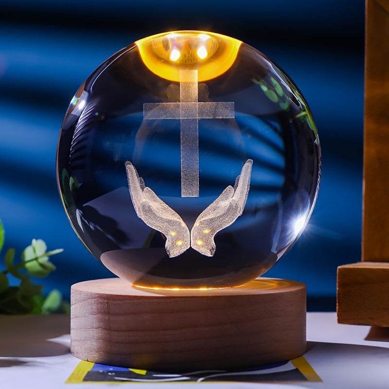 Luminescent crystal ball nightlight with wooden base showing 3D cross and praying hands design