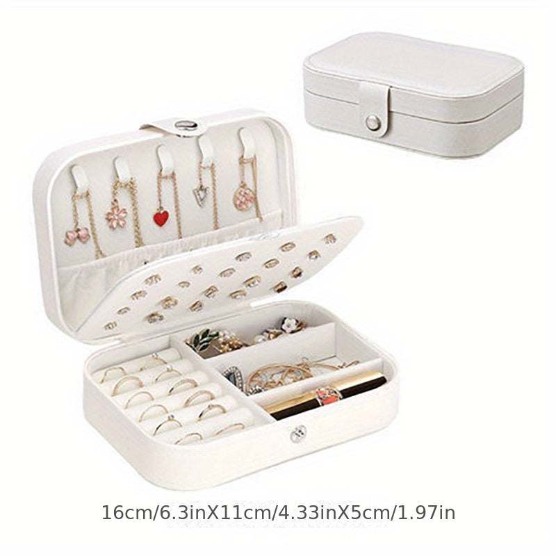White portable jewelry travel case with button closure, fabric interior, and multiple compartments for rings, earrings, and necklaces.